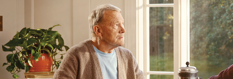 A patient looking confused as he stares at the camera. Actor portrayal